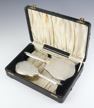 An Art Deco silver engine turned dressing table set comprising hair brush mirror and comb (comb a/f) boxed, Birmingham 1937 