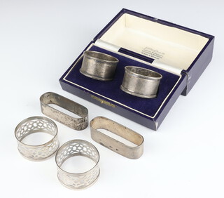 A pair of sterling silver napkin rings, 4 others 122 grams 