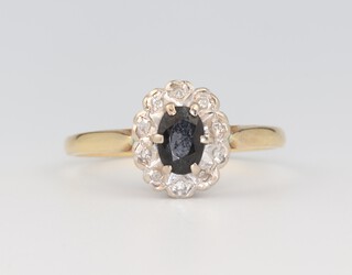 A yellow metal 18ct sapphire and diamond cluster ring 3.1 grams