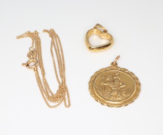 A 9ct yellow gold St Christopher 3.1 grams, a yellow metal 14k chain 1.1 grams and an 18ct yellow metal heart pendant 2.8 grams gross 