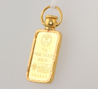 A fine gold 999.9 5 gram ingot numbered 790535, 30mm, 7.6 grams including loop 