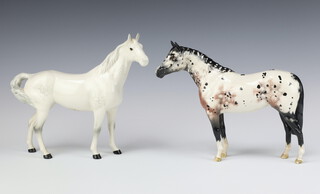 A Beswick figure of a standing Appaloosa stallion No 1772, 21cm (back leg f and r) together with a ditto swish tailed horse No 1182 rocking horse grey gloss 22cm both by Arthur Gredington 