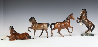 A Beswick figure of a Welsh Cob rearing brown gloss No 1014 by Arthur Gredington 26cm, 18cm, a ditto Spirit of Peace No 2916 brown gloss by Graham Tongue 12cm, a ditto Horse head tucked, leg up N0 1549 brown gloss by Pal Zalmen 19cm and a ditto Spirit of the Wind No 2688 brown gloss by Graham Tongue 20cm  