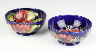 A circular William Moorcroft blue glazed bowl decorated anemones (f and r) 16cm, base impressed Moorcroft WM and 1 other decorated hibiscus, 16cm 