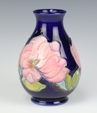 A Moorcroft blue glazed club shape vase decorated the Clematis pattern, base impressed Made in England Moorcroft and signature mark 20cm 