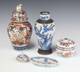 A 19th Century Japanese Imari vase and cover, the lid with Dog of Foe finial 28cm, an Imari jar and cover  7cm, a small boat shaped dish and an Imari dish and a lid, together with a blue and white vase 