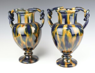 A pair of 19th Century continental pottery twin handled vases 31cm 