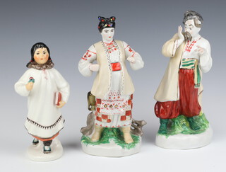 Three 20th Century Russian porcelain figures of standing ladies and a gentleman 24cm 