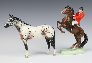 A Beswick figure of a standing Appaloosa horse 21cm (ear a/f) together with a Beswick figure of a huntsman on a rearing bay horse 868 23cm 