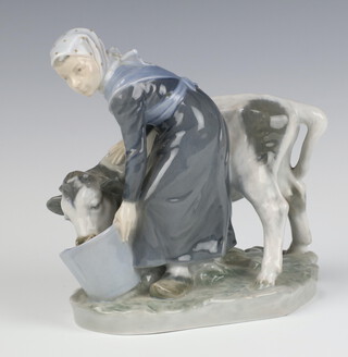 A Royal Copenhagen figure of a girl feeding a cow 779, 16cm  