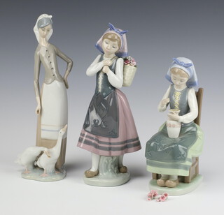 A Lladro figure of a standing girl with basket of flowers, base impressed E18E 25cm , ditto seated girl with vase of flowers C-250 22cm (flowers a/f), standing girl with geese 27cm, all boxed 
