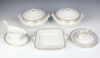 A 42 piece Spode Queens Gate pattern dinner service comprising 2 twin handled tureens and covers, 12 dinner plates, 7 side plates, 5 small side plates, 12 tea plates, bread plate, cream jug, sauce boat and stand