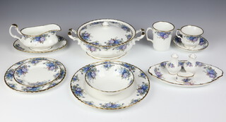 A 90 piece Royal Albert Moonlight Rose pattern dinner service comprising 2 twin handled tureens and covers, 8 dinner plates, 8 side plates, 8 pudding bowls, 8 soup bowls, oval meat plate, rectangular butter dish, circular butter dish, oval dish, 2 oval twin handled dishes (seconds), sauce boat and stand, 6 mugs (all seconds), 3 breakfast cups (all seconds), 3 breakfast saucers (all seconds), 8 tea plates, 8 cups, 8 saucers, cream jug (second), sugar bowl, 4 pepper pots, 4 napkin rings 