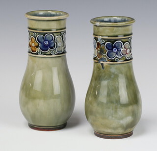 A pair of Royal Doulton green salt glazed oviform vases decorated with a band of stylised floral heads, bases impressed LB 7735B 16cm 