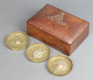 A rectangular carved hardwood box, the lid with badge of the Royal Artillery 6cm x 18cm x 12cm together with 3 Trench Art ashtrays decorated the Somali Land Camel Corps Crest and button 