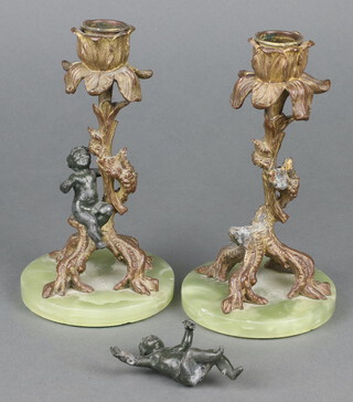 A pair of gilt metal candlesticks in the form of tree stumps with bacchanalian figure raised on circular green veined marble bases 16cm x 9cm (1 figure has been glued and is loose) 