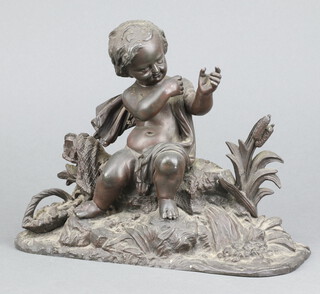 A 19th Century  spelter figure of a seated cherub on an oval base 17cm x 23cm x 8cm 