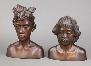 A Bali carved hardwood portrait bust of a gentleman 27cm x 20cm x 9cm and 1 other of a lady 