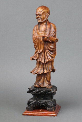 A Chinese carved hardwood figure of a standing deity with glass eyes 32cm x 8cm 
