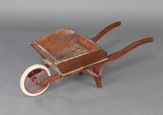 A child's wooden wheelbarrow with solid rubber tyre 79cm h x 76cm w x 35cm d 