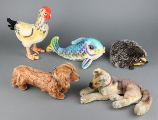 A Steiff figure Waldi Dachshund no.1317,00 13cm x 24cm, labelled and with stud, a Steiff figure Flossy Fish no.2322.00 with label and ear stud, ditto Joggi Hedgehog no.1670/17 with label and eat stud, standing figure of a cockerel no.1325,04 with ear stud (loose) 26cm, a Steiff figure of a reclining Alsatian (no label) stud to ear 27cm
