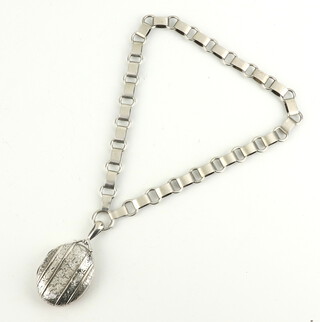 A Victorian style oval silver locket on a ditto chain 32.3 grams 