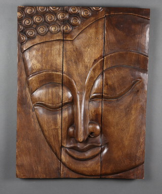 An Eastern carved hardwood panel formed of 3 planks depicting a Buddha's face 78cm h 
