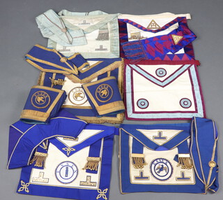 A quantity of Masonic regalia comprising Mark Master Masons apron, Provincial Grand Officers full dress and undress apron and gauntlets (Essex Deacon), Provincial Grand Officers undress apron (Essex Junior Warden), Royal Arch Companions apron and sash, a Masters apron, all contained in a suitcase 