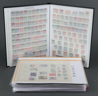 A stock book of mint and used world stamps including Germany, Norway, Sweden, Denmark and Italy together with a loose leaf album of Elizabeth II GB mint stamps including 7 presentation packs and small collection of American and Chinese stamps 
