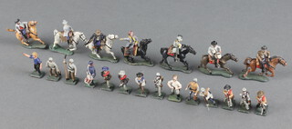 A collection of miniature lead painted figures of cowboys 