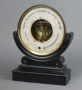 A 19th Century aneroid barometer with silvered dial contained in a gilt metal circular case raised on an ebony stand 20cm 
