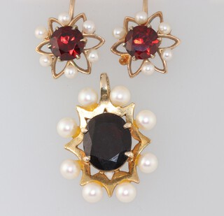 A 9ct yellow gold garnet and pearl pendant 25mm together with a pair of similar ear studs (1 pearl detached and 1 missing) 