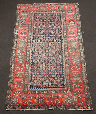 An orange, green and blue ground Caucasian rug with rectangular central medallion within a multi row border 284cm x 155cm 