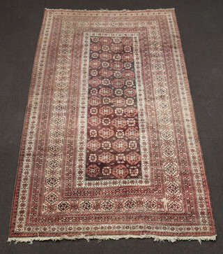 A tan and white ground Afghan rug the central rug with octagons within a multi row border, 287cm x 167cm 