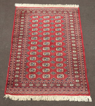 A red and blue ground Bokhara carpet with 39 octagons to the centre 188cm x 127cm, light moth 