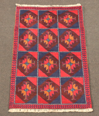 A red, blue and tan ground Belouche rug formed of 12 square medallions 136cm x 85cm 
