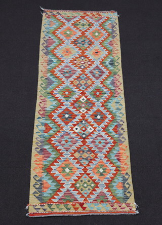 A yellow and brown ground Chobi Kilim runner with all over diamond design 240cm x 81cm 