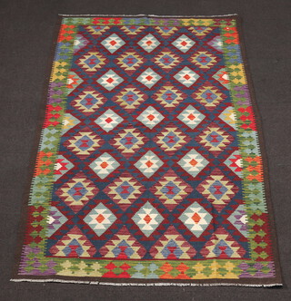 A brown, black and green ground Maimana Kilim rug with diamond design 252cm x 161cm 