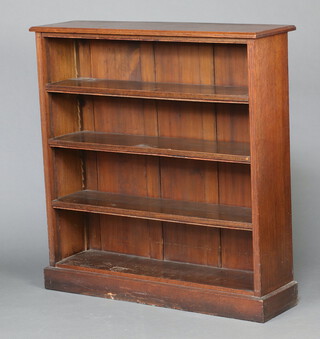 A Victorian oak open bookcase fitted adjustable shelves raised on a platform base 111cm h x 107cm w x 31cm d 