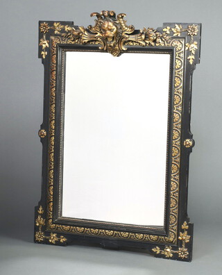A 19th Century Continental rectangular plate mirror contained in a gilt and ebonised frame surmounted by a lion mask 118cm h x 85cm w  