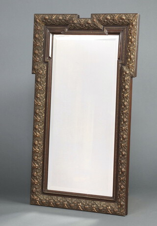 A 19th Century rectangular bevelled plate mirror contained in a decorative gilt frame 100cm h x 74cm w