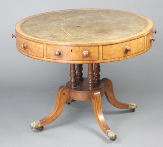 A Georgian mahogany drum table with revolving inlaid and green leather writing surface, fitted 4 drawers ( and 4 false drawers ) and raised on 4 turned columns with circular base ending in splayed feet with brass paw casters 73cm h x 95cm diam. 