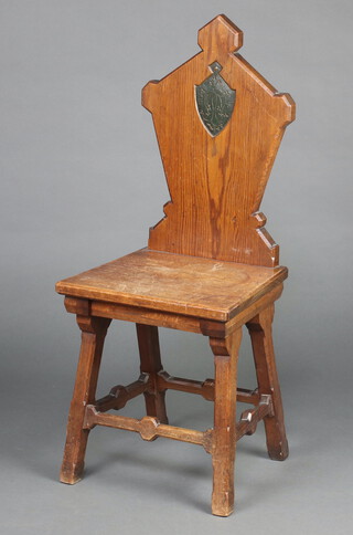 A 19th Century pitch pine hall chair, the shaped solid back with shield and monogram to the centre raised on square supports with H framed stretcher 99cm h x 41cm w x 34cm d (seat 23cm x 23cm) 