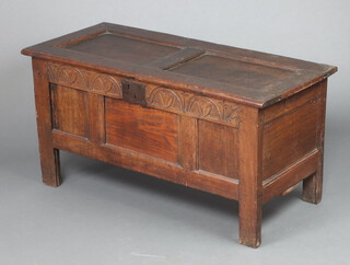 An 18th Century oak coffer of panelled construction with a hinged lid, fitted a candle box, 54cm h x 109cm w x 46cm d