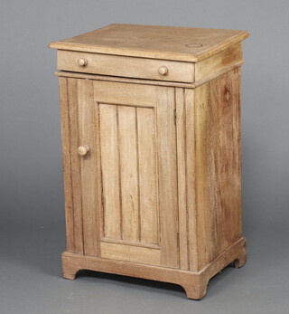 A 19th Century  bleached mahogany enclosed washstand with hinged lid and cupboard enclosed by panelled doors, raised on bracket feet 80cm h x 53cm w x 41cm d (heavily sun bleached  and warped to the top) 