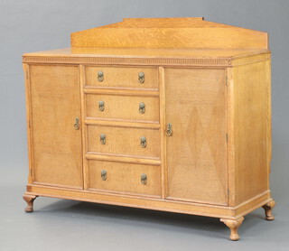 A 1930's light oak sideboard with raised back and 4 drawers flanked by cupboards, raised on cabriole supports, back marked CWS 127cm x 150cm x 55cm 