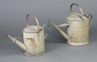 A galvanised 2 gallon watering can together with a ditto half gallon 