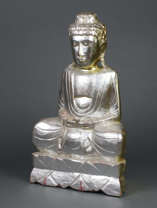 A silver and gold painted carved wooden figure of a seated Buddha 79cm h x 46cm w x 25cm d 