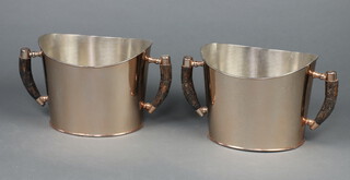 A pair of silver oval silver plated twin handled wine coolers with simulated stag horn handles 21cm x 36cm x 23cm 