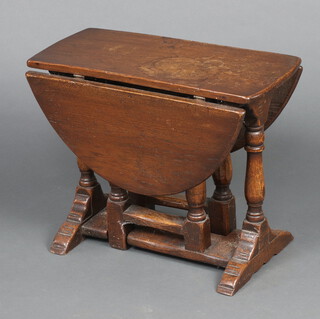 An oak oval drop flap gate leg tea table 43cm h x 56cm w x 25cm d 